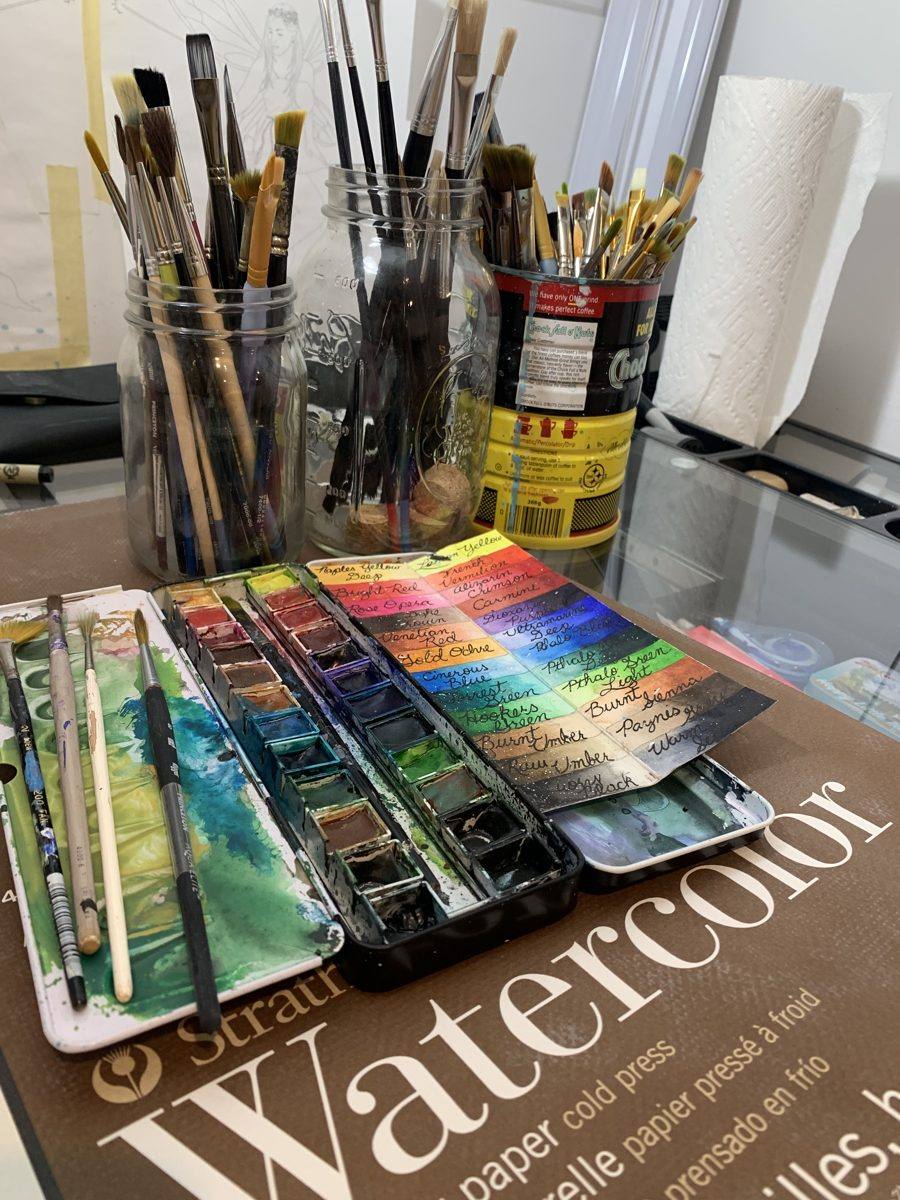 The artist's paint palette and handwritten color charts on his worktable